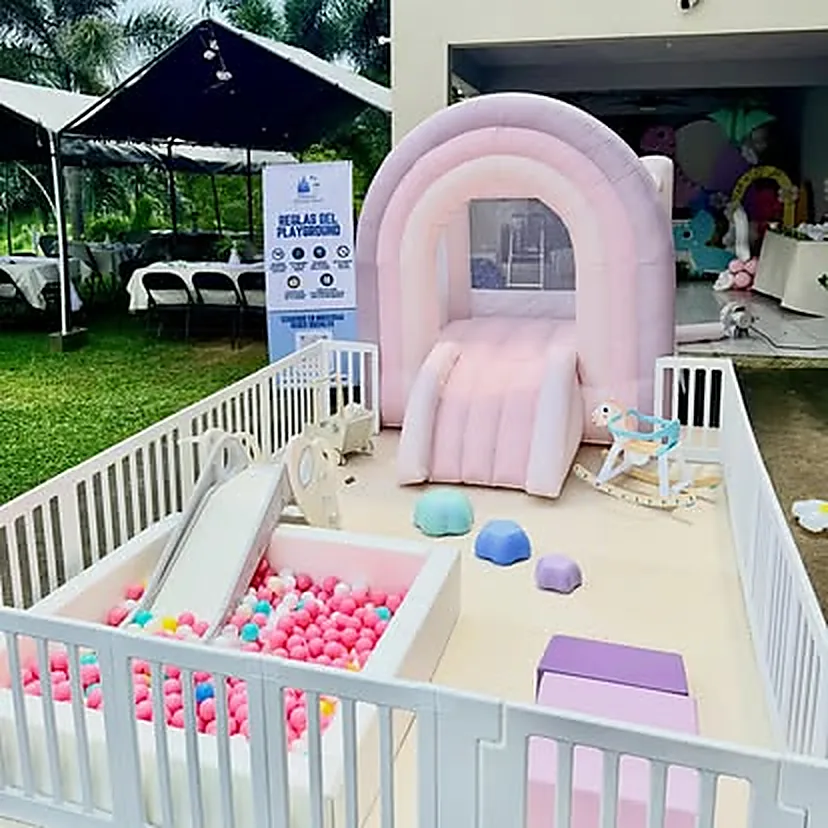 Arco inflable rosa pastel con tobogán, piscina de pelotas rosa y caballito mecedor